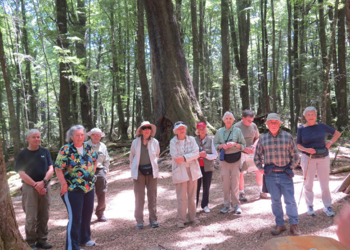 WWURA members standing in group within a forest surrounded by trees